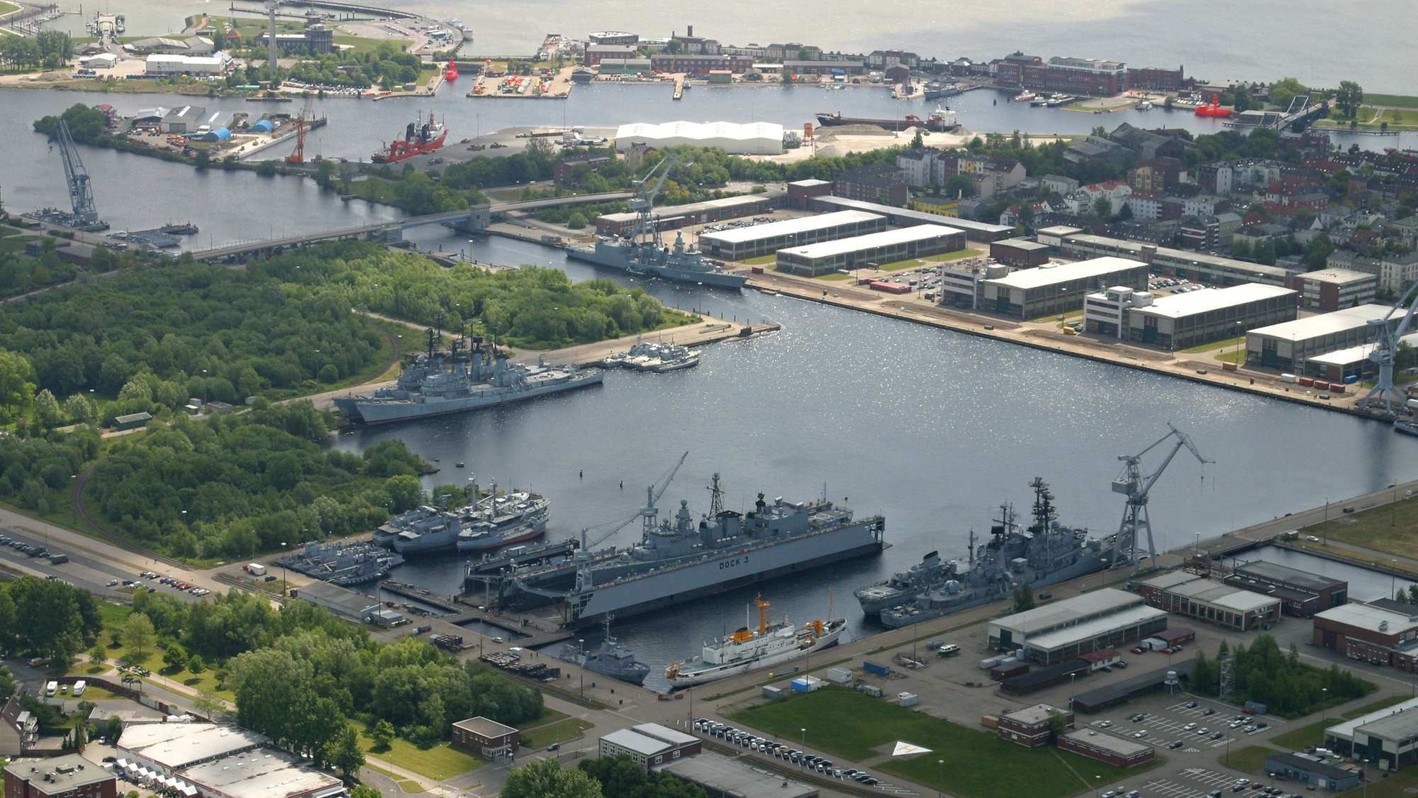 Mehr über den Artikel erfahren Marinearsenal – Sanierung des Stützpunkts (Erneuerung der Tore, Abriss und Neubau der Hallen inkl. Neubau eines Trockendocks)